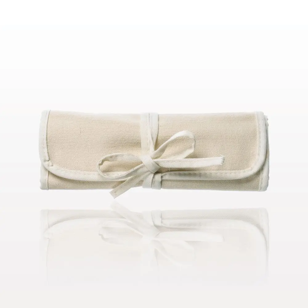 A FACES by Brandi 8 Piece Brush Set with cotton roll & tie pouch with a bow tied around it.