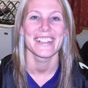 A woman wearing a baltimore ravens jersey.