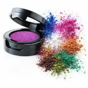 Colorful eyeshadow palette with scattered pigments.