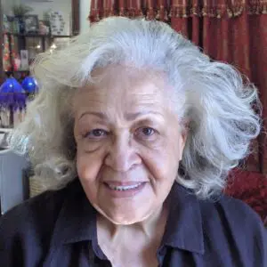 A woman with gray hair in a black shirt.