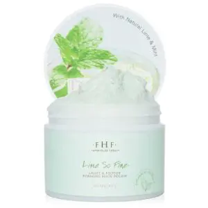 A jar of FHF Lime So Fine Foaming Body Polish with a mint leaf on top.
