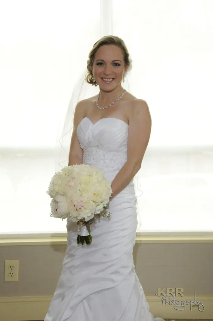 Bride in white wedding dress with bouquet.