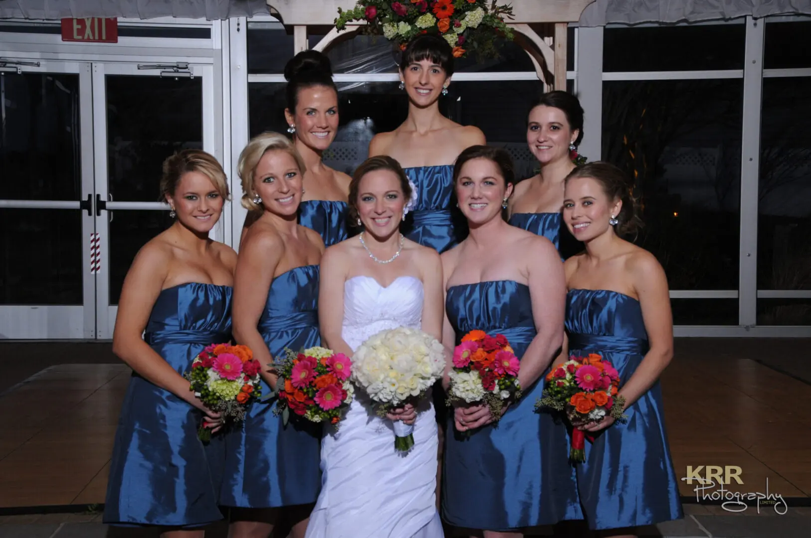 Bride and bridesmaids in blue dresses.