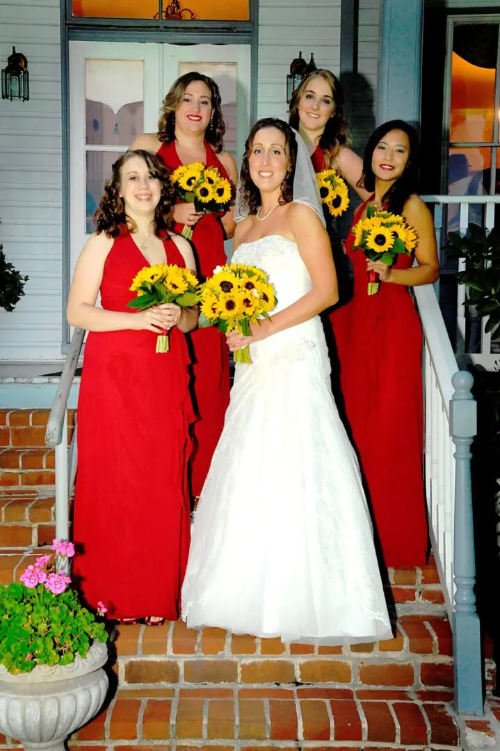Bride and bridesmaids in red dresses.