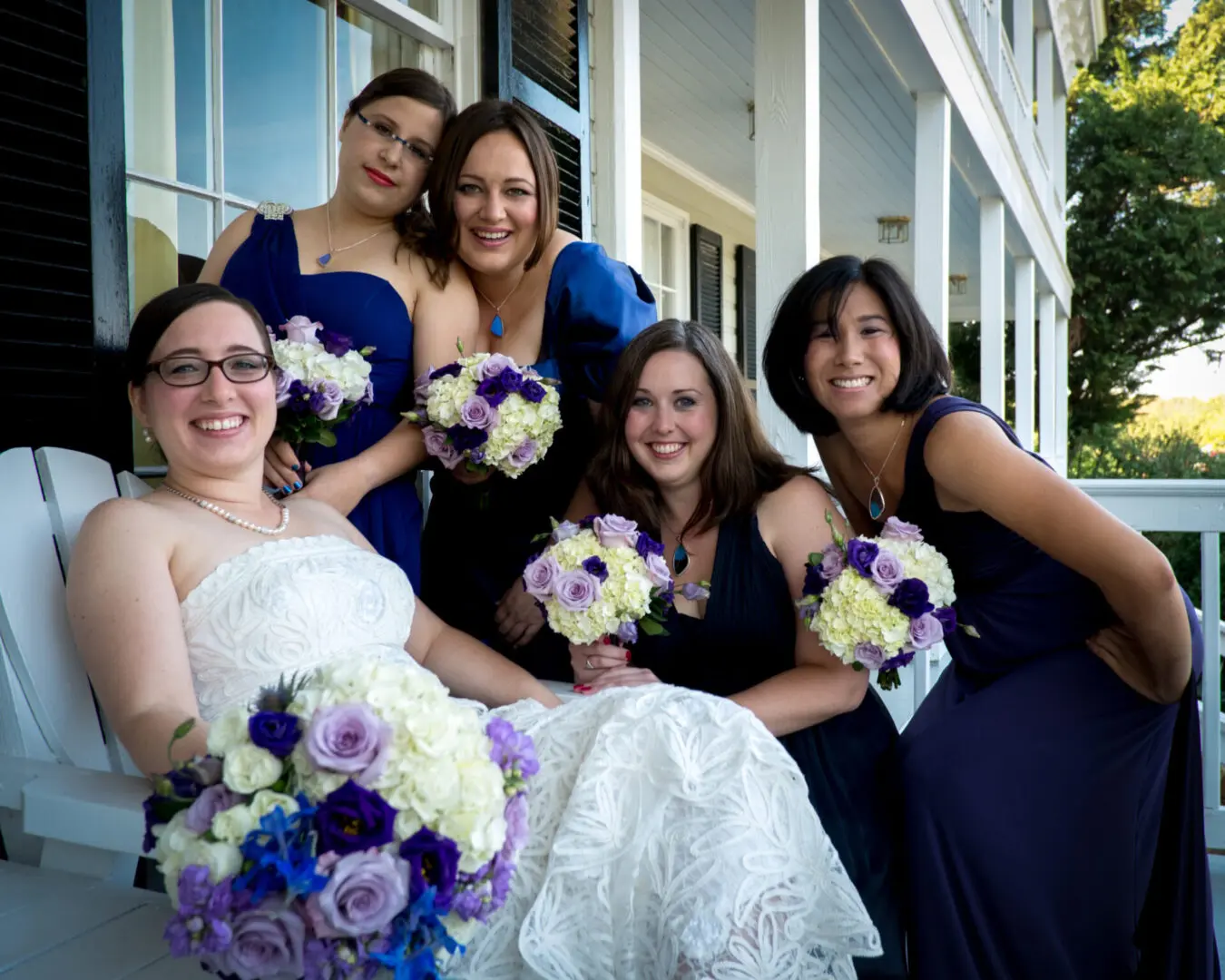 A Bride and bridesmaids in blue dresses.