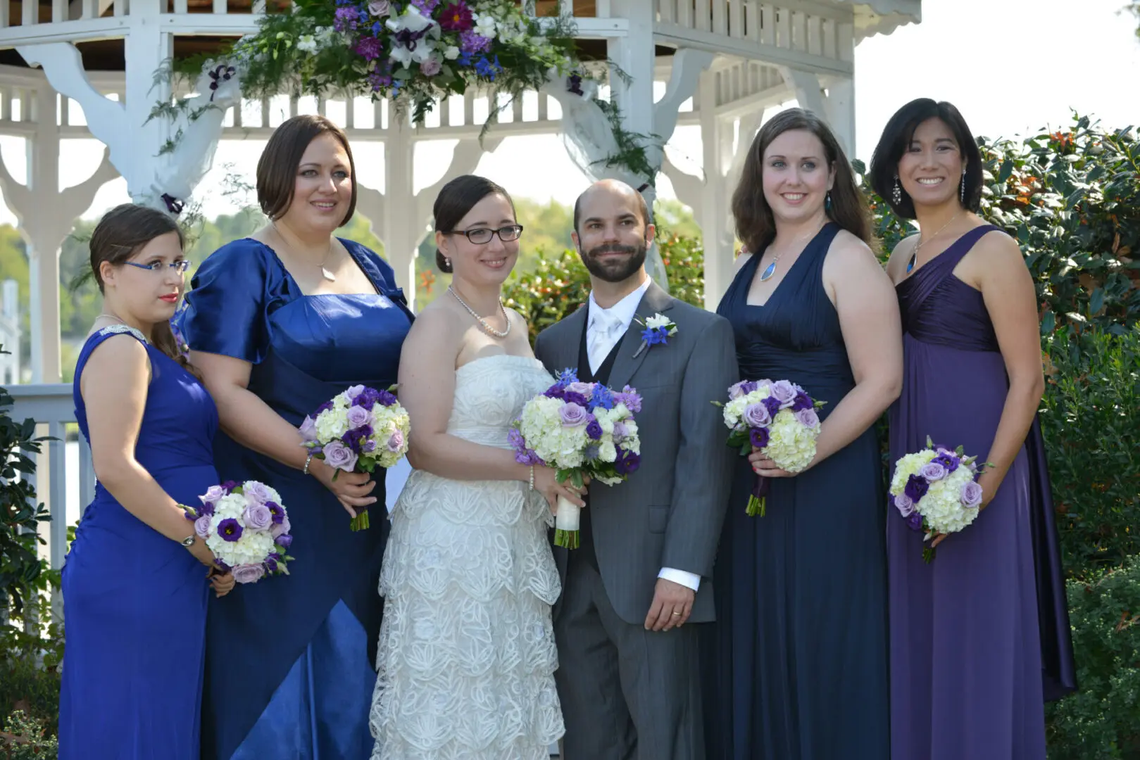Bride and bridesmaids in wedding gazebo.