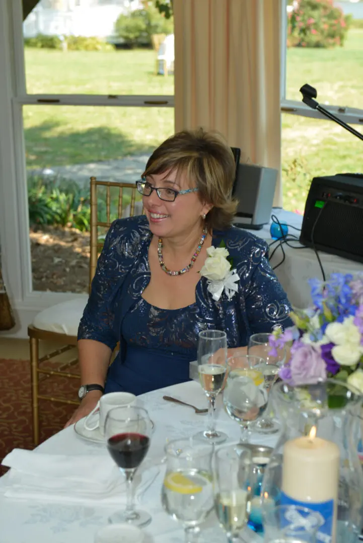 Woman in blue dress at wedding reception.
