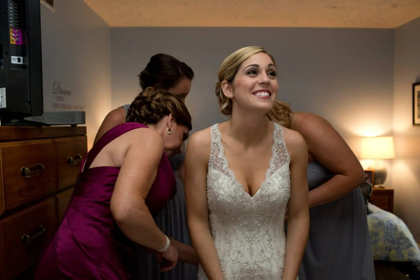 A Bride getting dressed with bridesmaids.