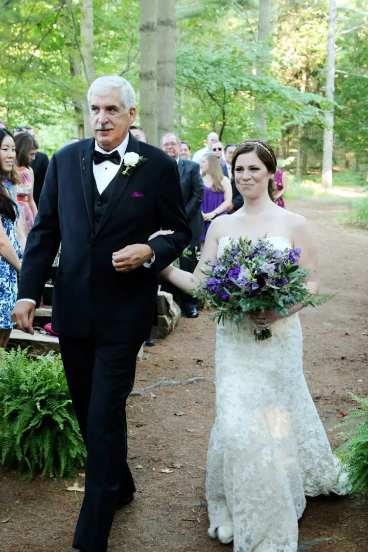 Father walks daughter down aisle.