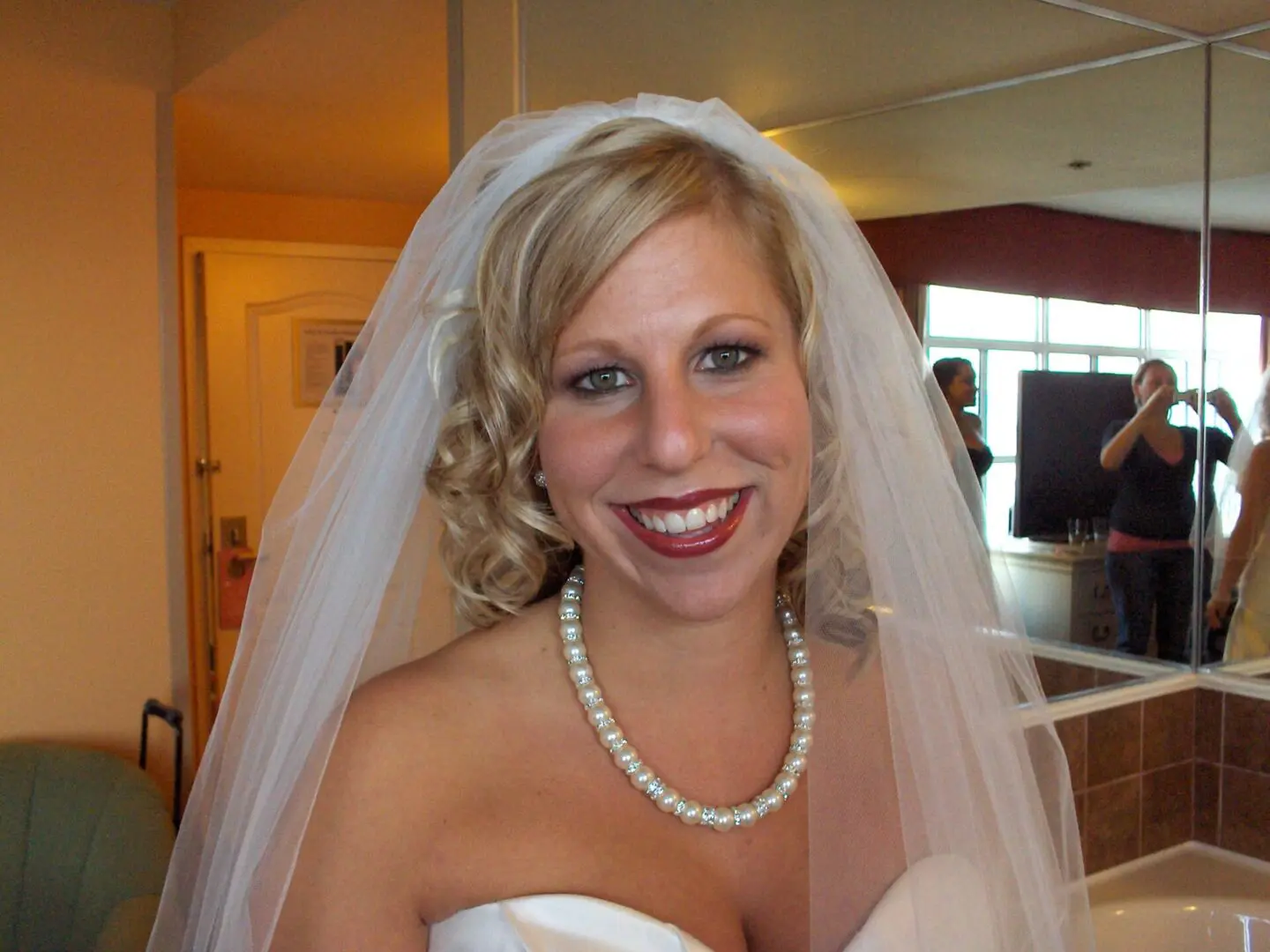 Bride in wedding veil and pearls.
