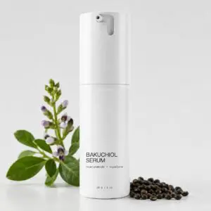 Bakuchiol serum bottle with plant and seeds