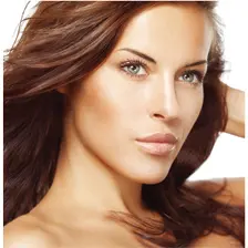 Woman with long hair, looking confidently.