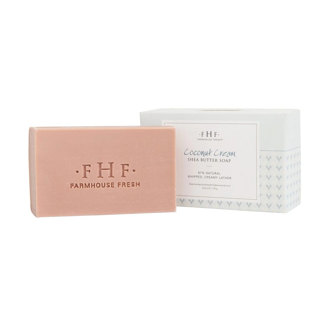 A soap bar with a pink label and a white box.