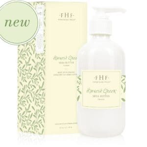 A bottle of body lotion with green leaves and a box next to it.