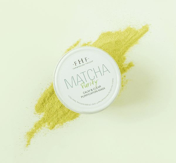 A tin of matcha powder on a white background.