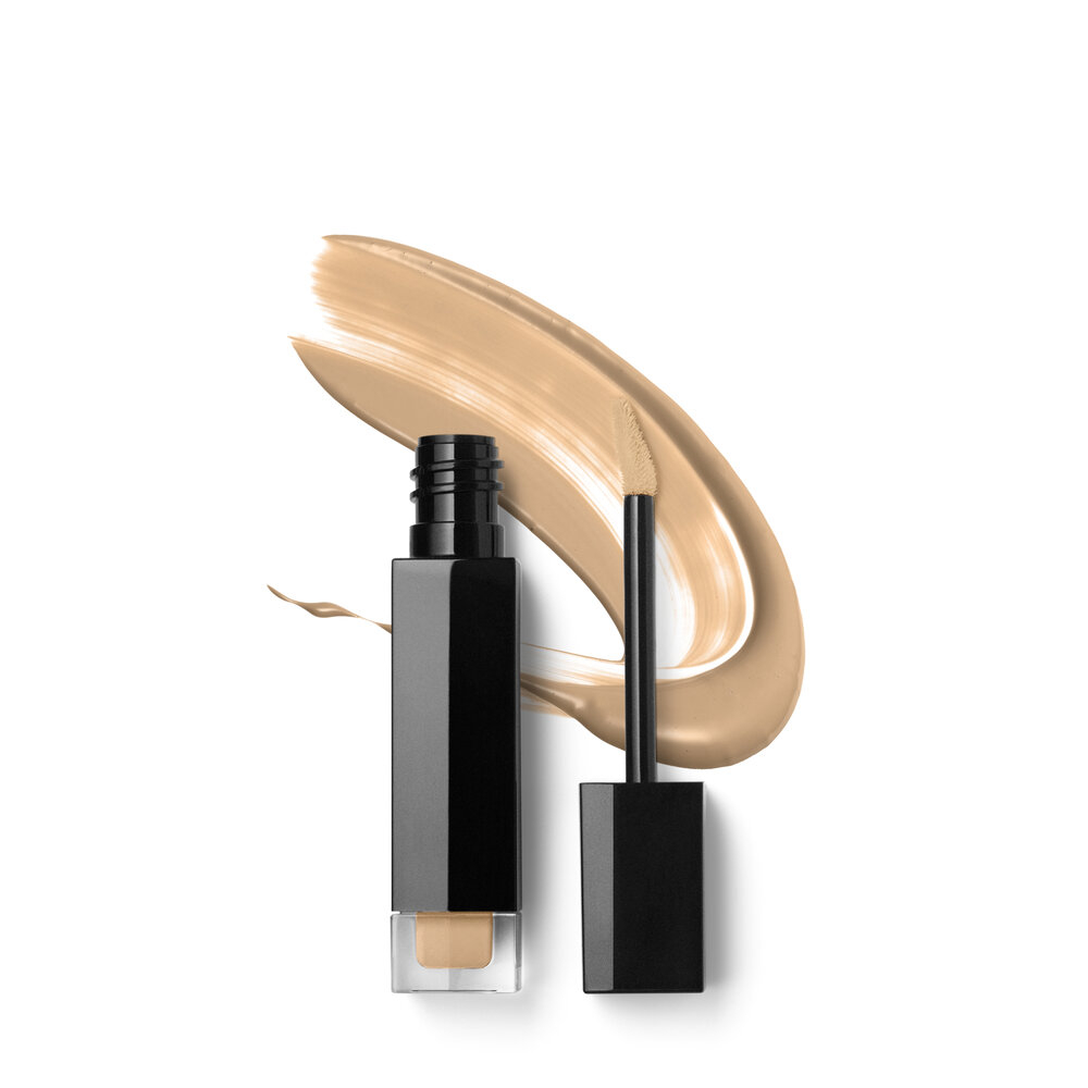 A bottle of concealer on a white background.