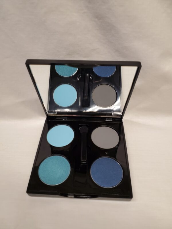 A blue eyeshadow palette on a white surface.