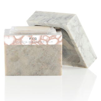 A white marble soap bar with a pink label.