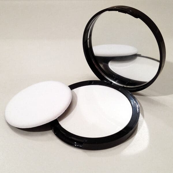 Black compact powder with mirror and puff.