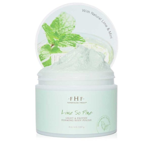 A jar of FHF Lime So Fine Foaming Body Polish with a mint leaf on top.