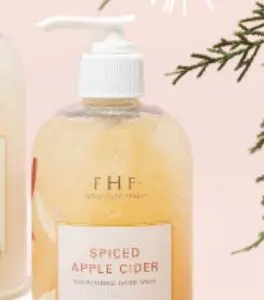 Two bottles of Farmhouse Fresh LIMITED Holiday Hand & Body Wash "Spiced Apple Cider" on a white background.